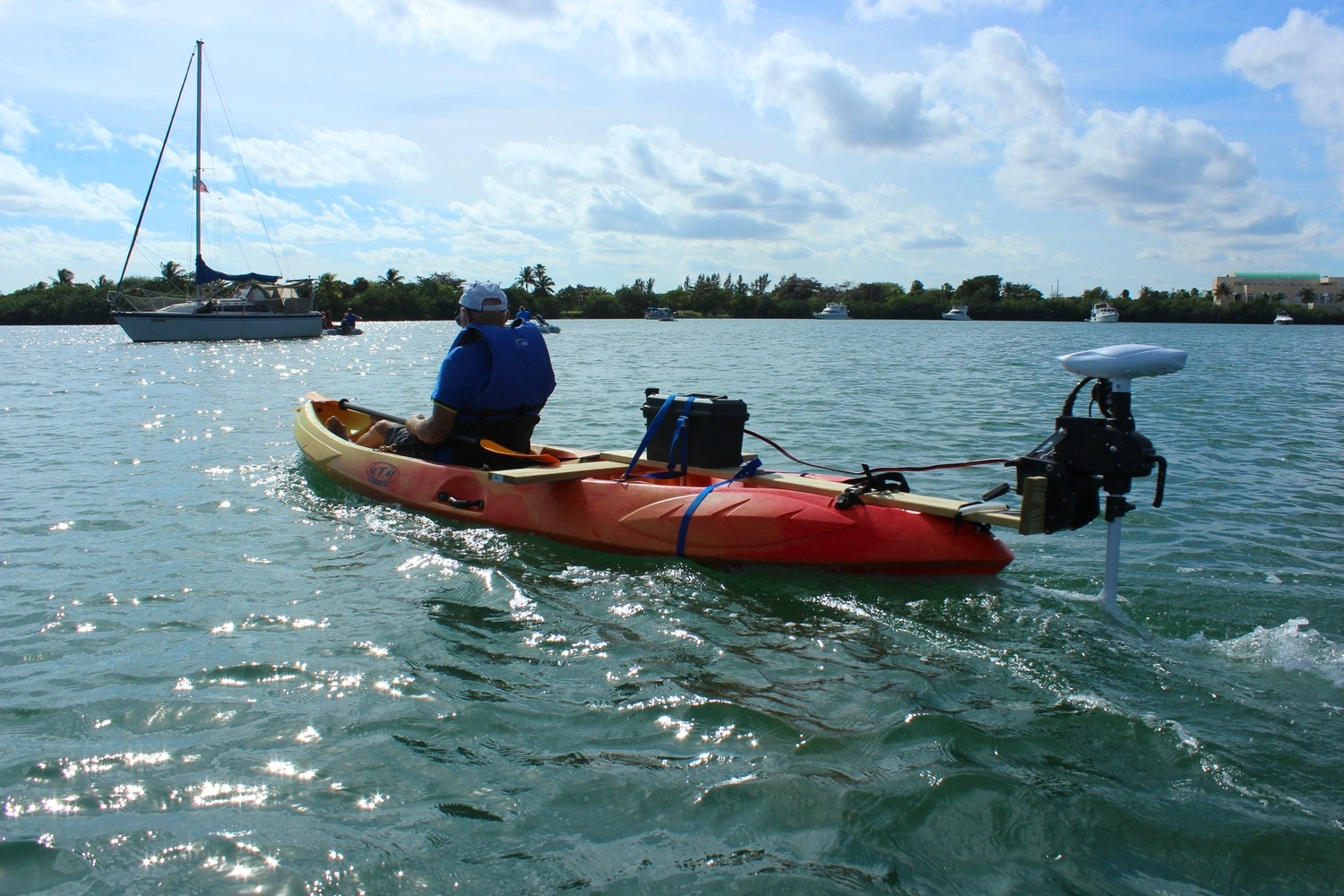 Stern mounted kayak trolling motor with tiller steering.